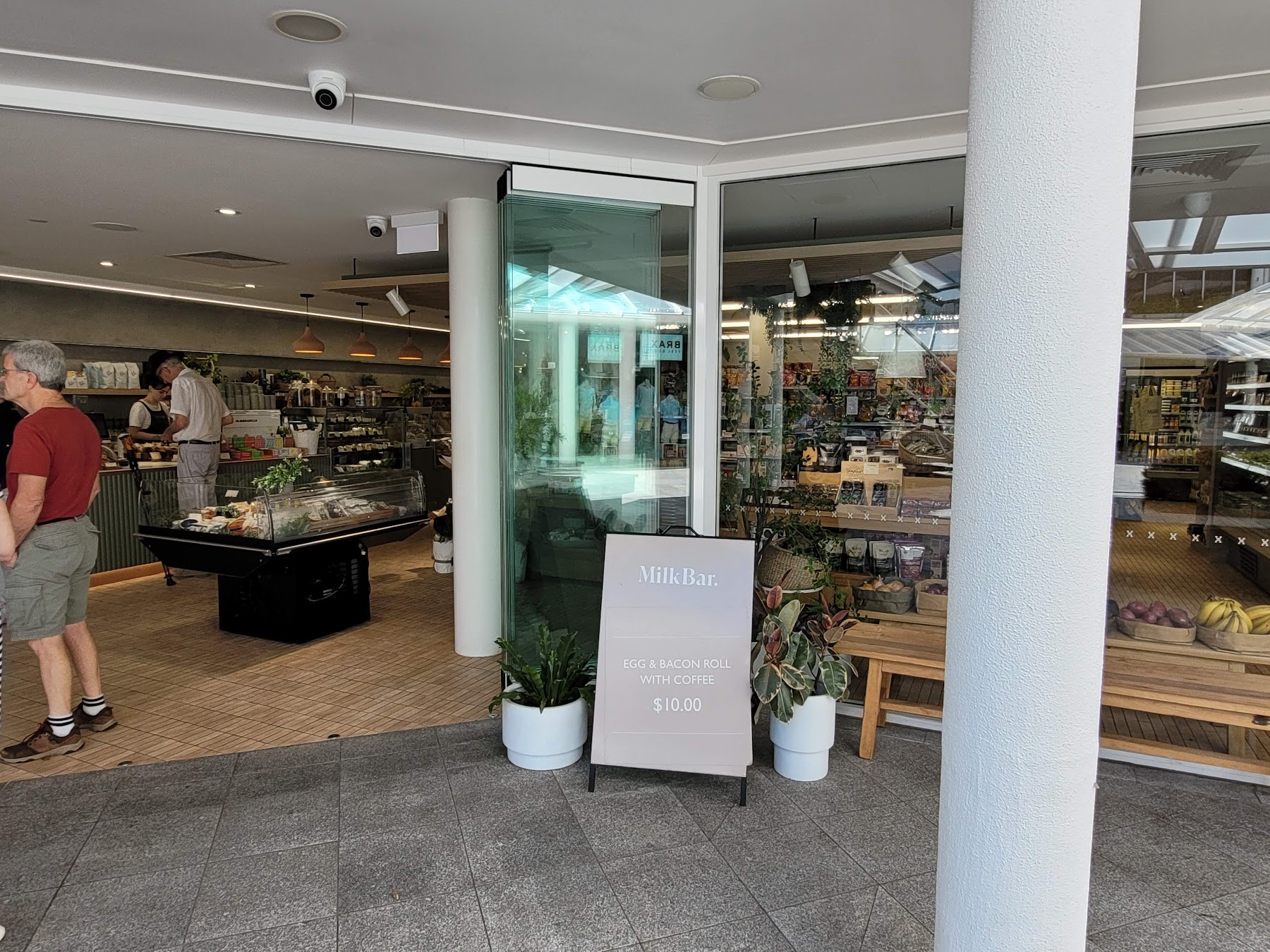 Open-air Hastings Street cafe with a deli cabinet, pantry shelves and fresh produce
