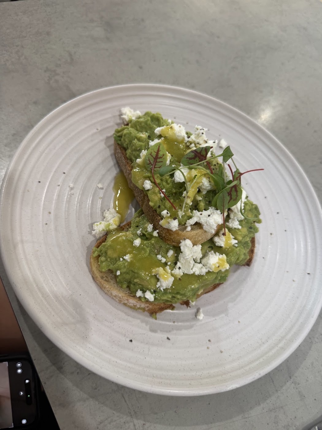 Avocado smash on sourdough with feta and micro greens